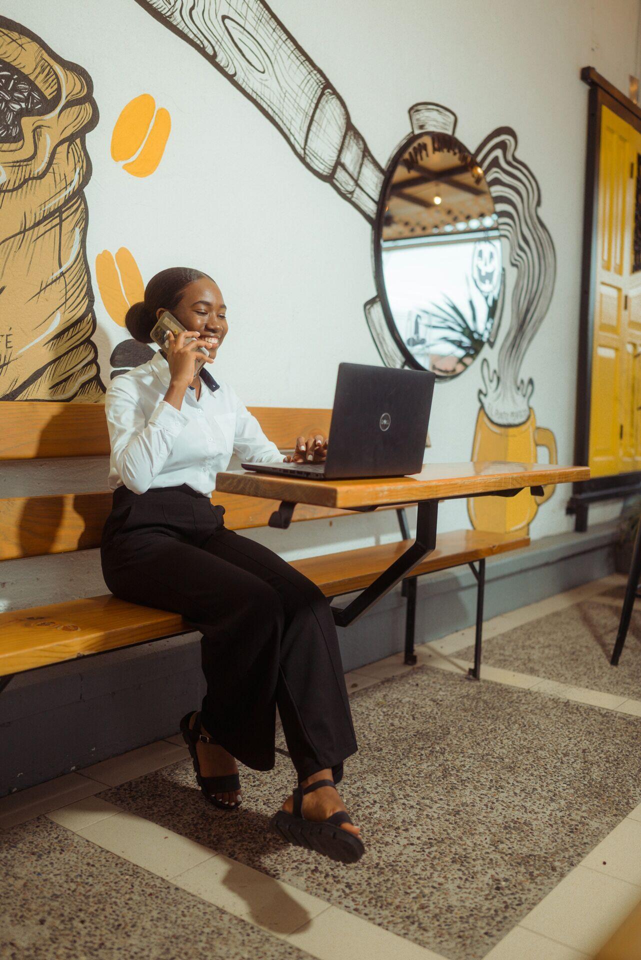 Two professionals at laptops in a modern coworking space in Nairobi, engaged in a video call