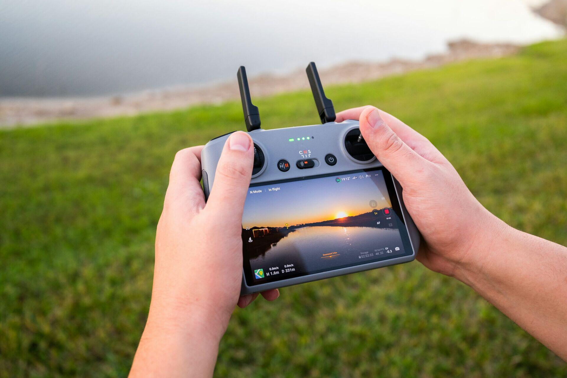 Soldier or relief coordinator holding a rugged encrypted radio handset in a field or jungle environment