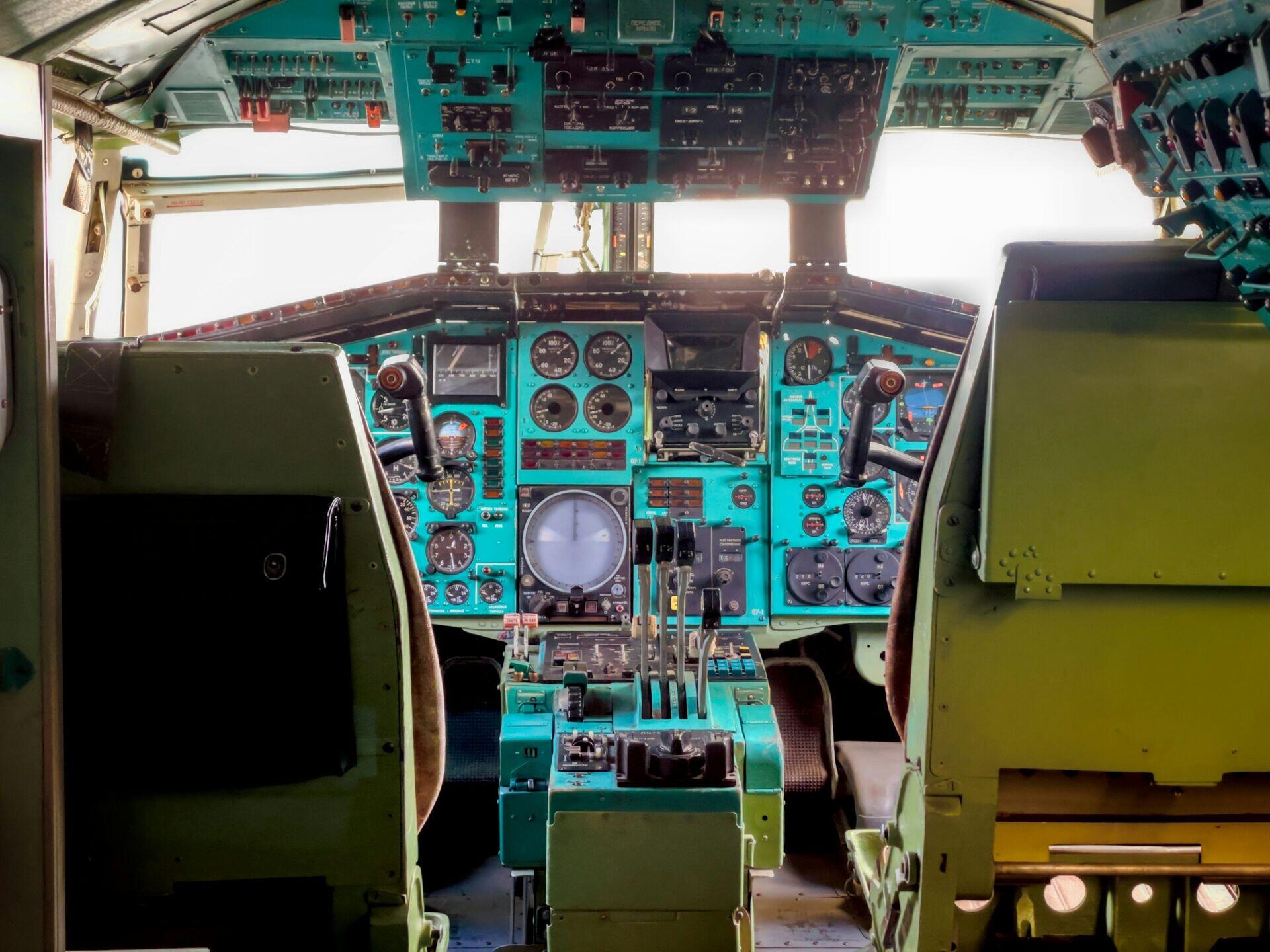 Cockpit view of a pilot checking navigation instruments during aircraft approach to landing