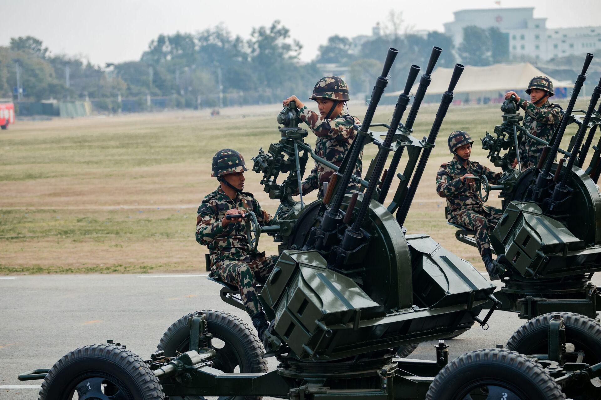 Soldiers in field gear gathered around a ruggedized tablet displaying a tactical map in an outdoor setting