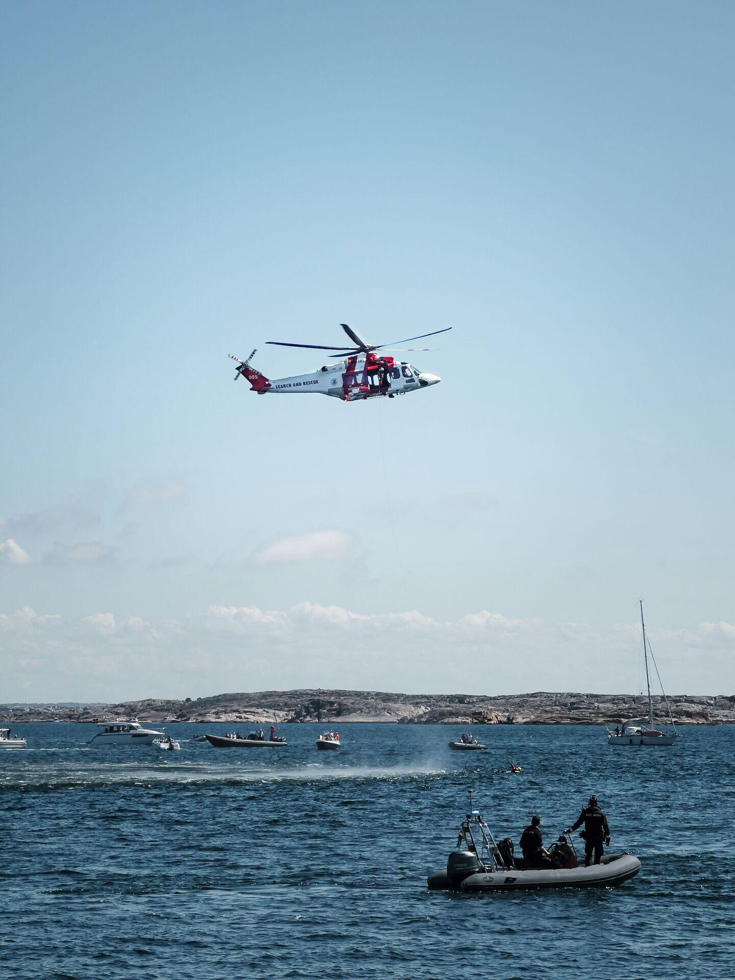 Uniformed coast guard crew on a patrol boat at sea, scanning the horizon
