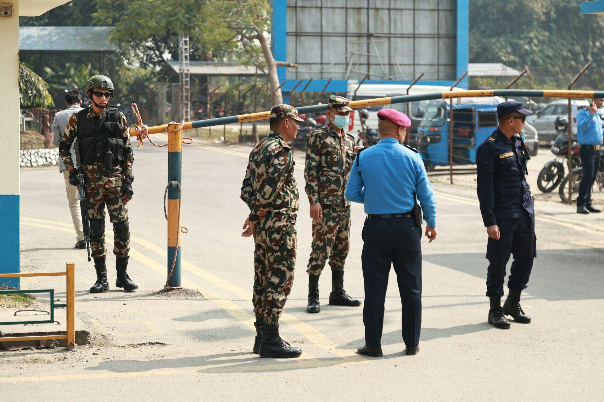 Uniformed security officers monitoring a large crowd at an outdoor public event