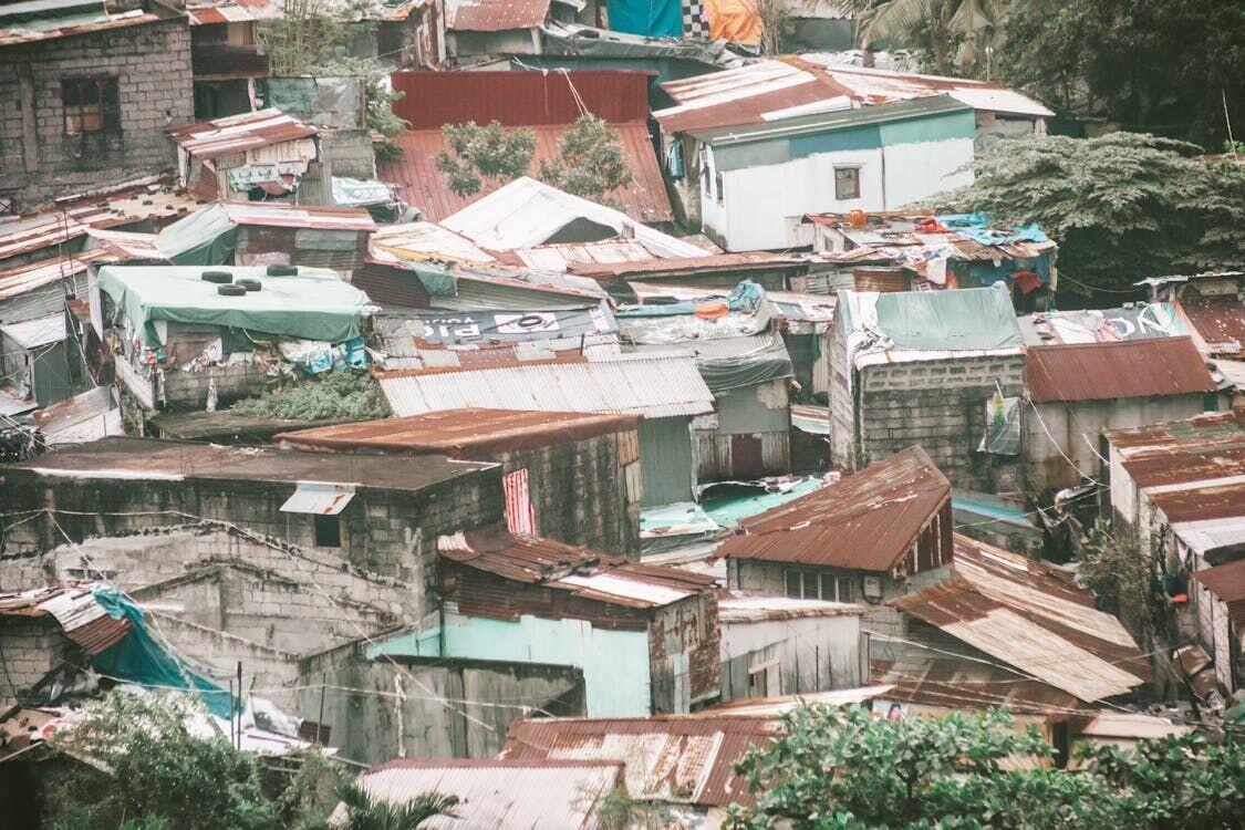 Census workers with tablets interviewing residents in a densely packed urban neighbourhood