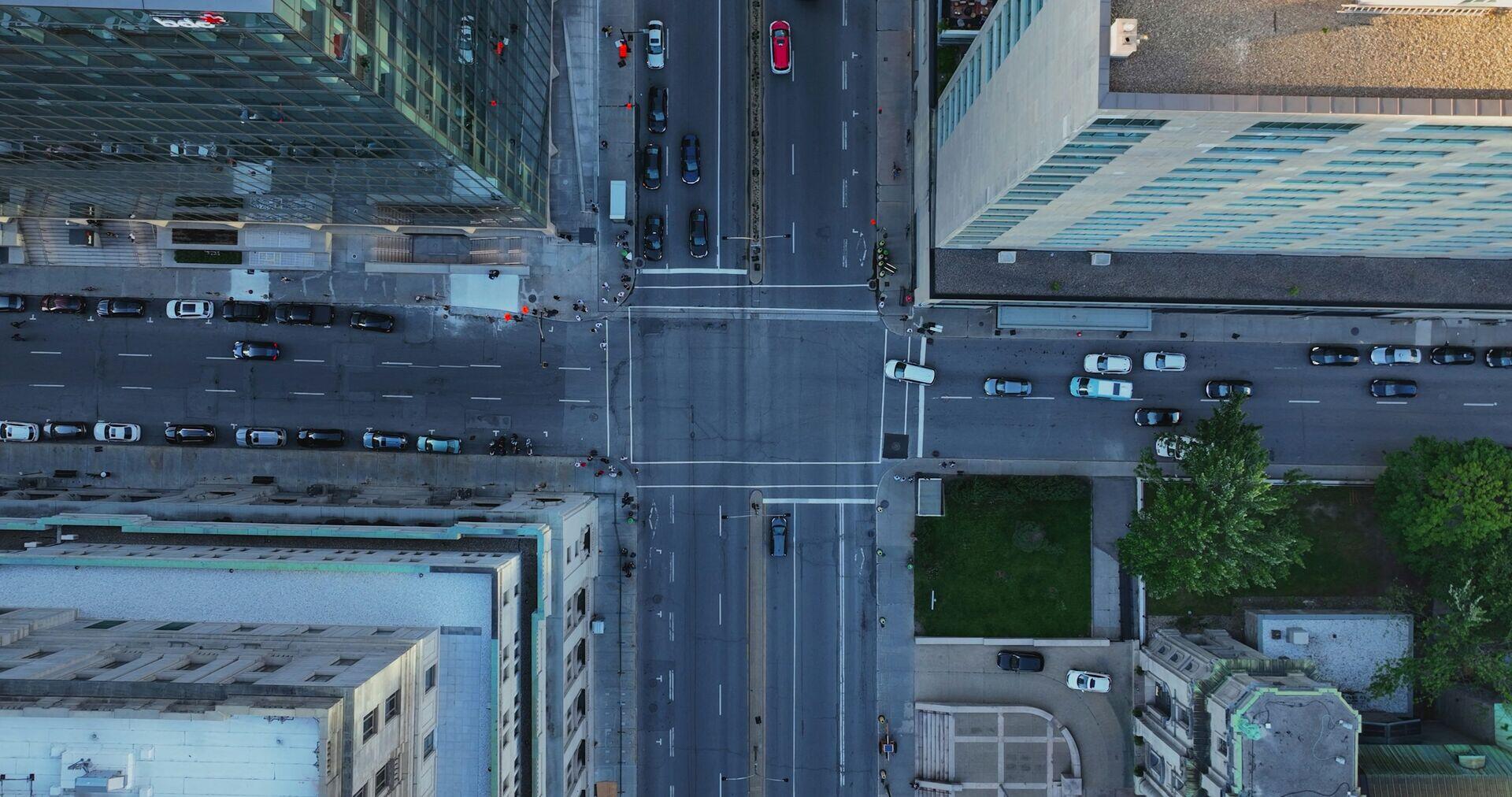 Crowds of commuters boarding buses at a busy urban transit stop in a large city